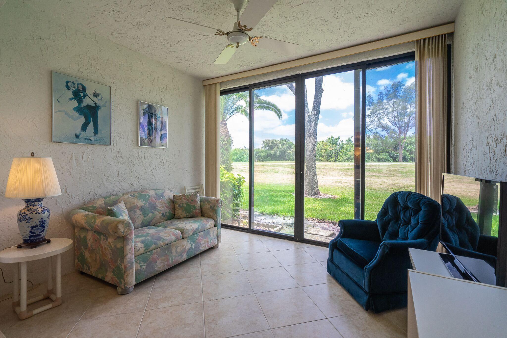 9276 Vista Del Lago, Unit E Boca Raton, FL 33428 - Photo 3 of 23 a living room with furniture and a large window