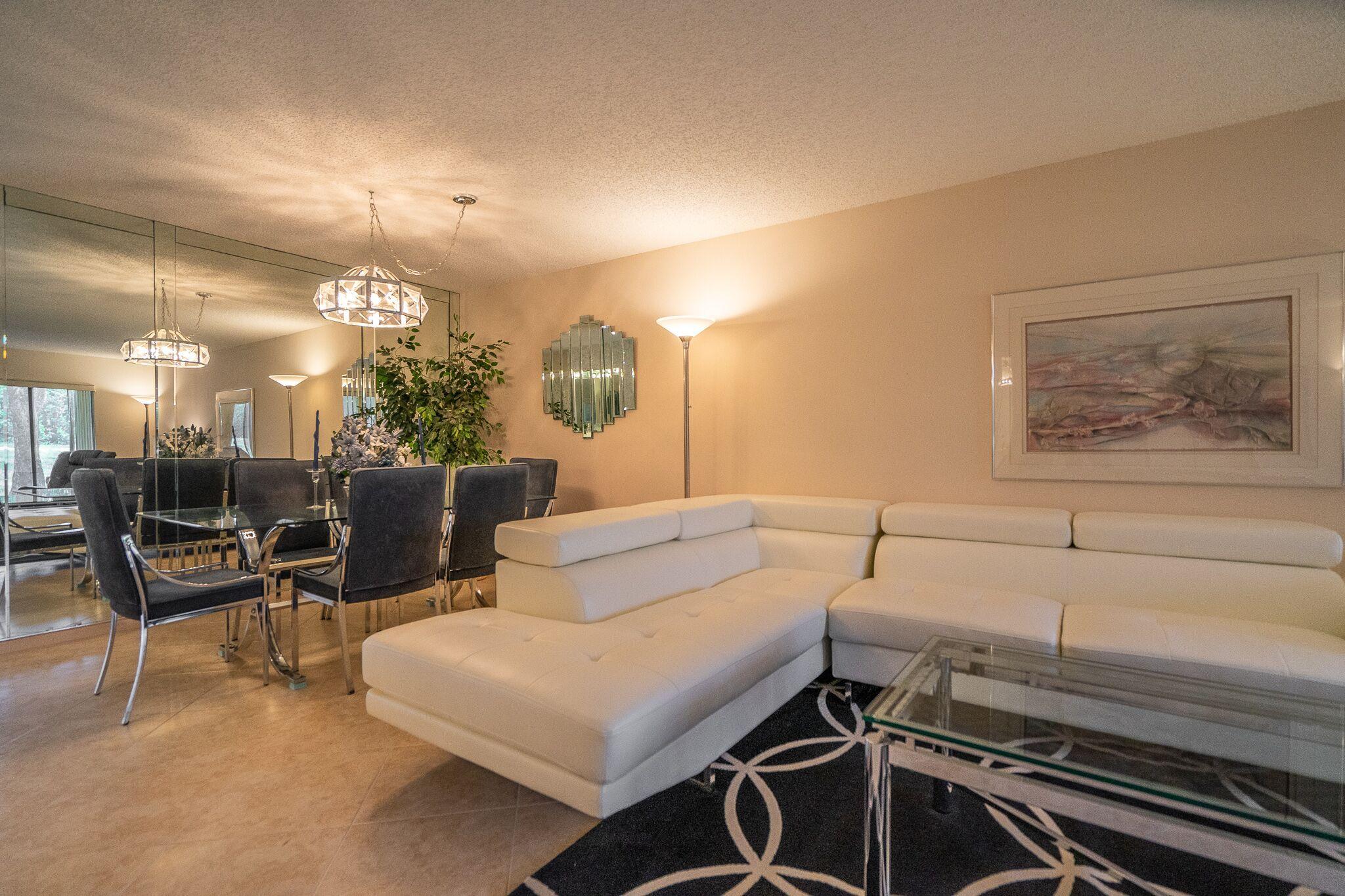9276 Vista Del Lago, Unit E Boca Raton, FL 33428 - Photo 6 of 23 a living room with furniture and a flat screen tv
