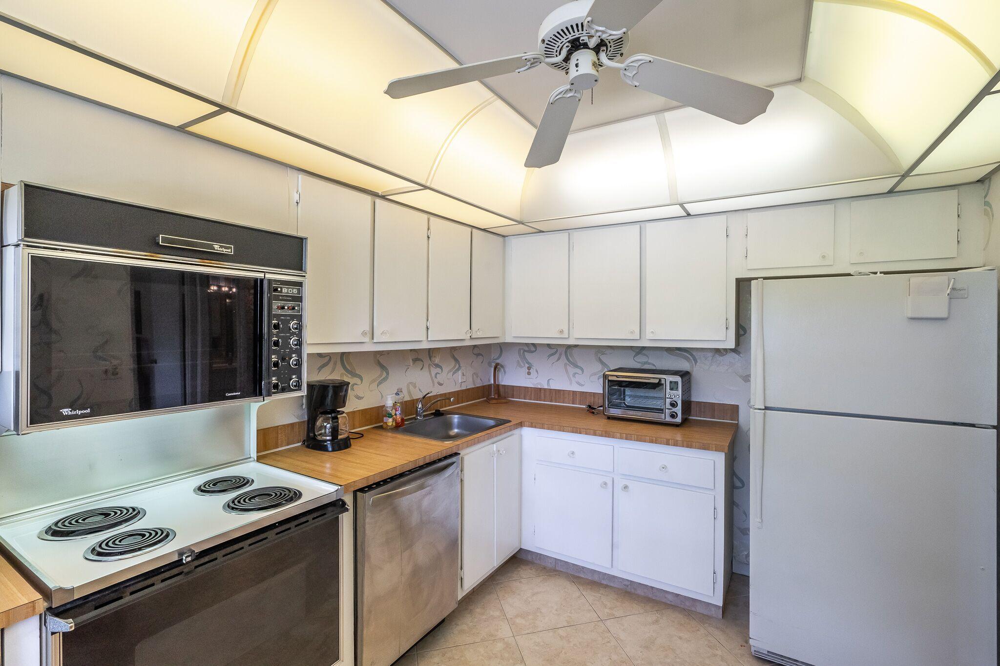9276 Vista Del Lago, Unit E Boca Raton, FL 33428 - Photo 8 of 23 a kitchen with a sink appliances and cabinets