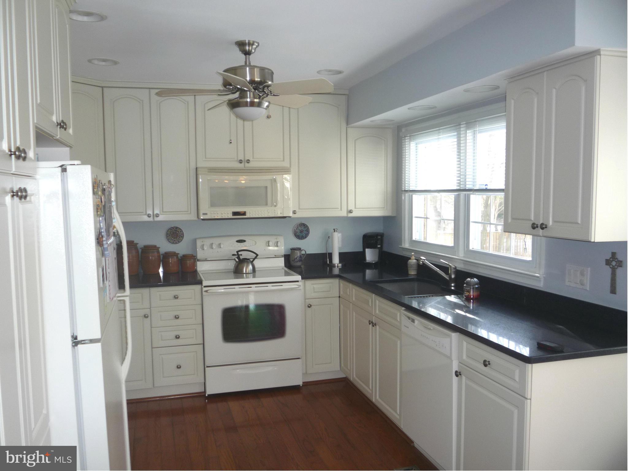 250 Lindenhall Court Riva, MD 21140 - Photo 4 of 29 a white kitchen with granite countertop a sink and white stainless steel appliances