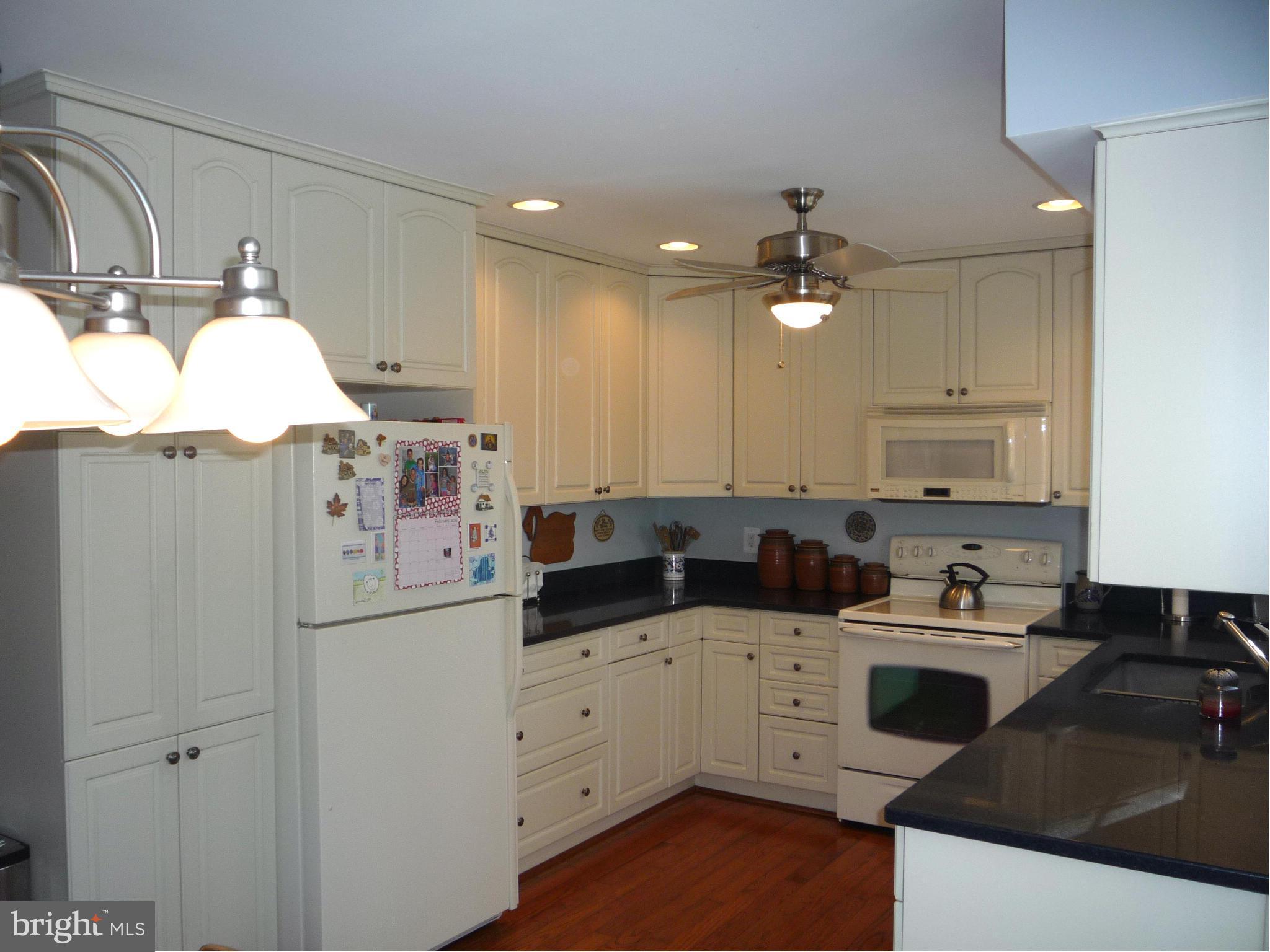 250 Lindenhall Court Riva, MD 21140 - Photo 5 of 29 a kitchen with a sink dishwasher and white cabinets