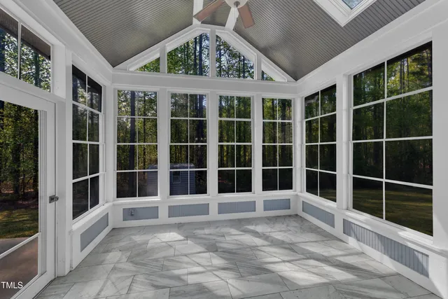 a view of empty room with wooden floor and fireplace