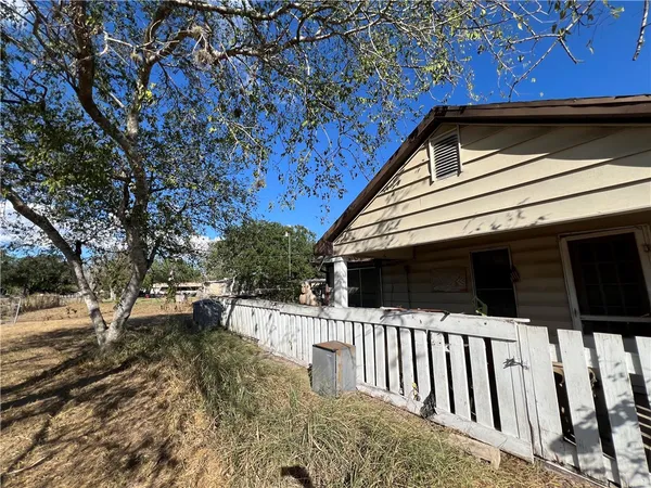 a view of house with backyard and trees