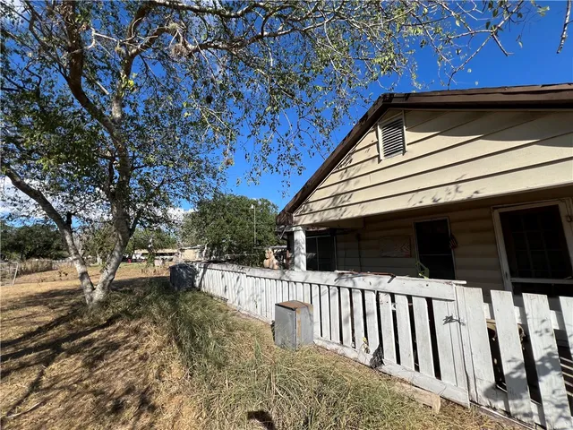 a view of house with backyard and trees