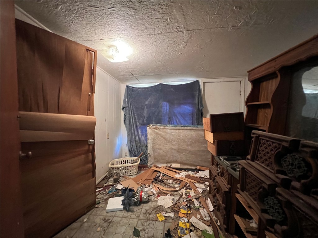 113 4th Street Mathis, TX 78368 - Photo 12 of 26 a living room with a couch and a stove