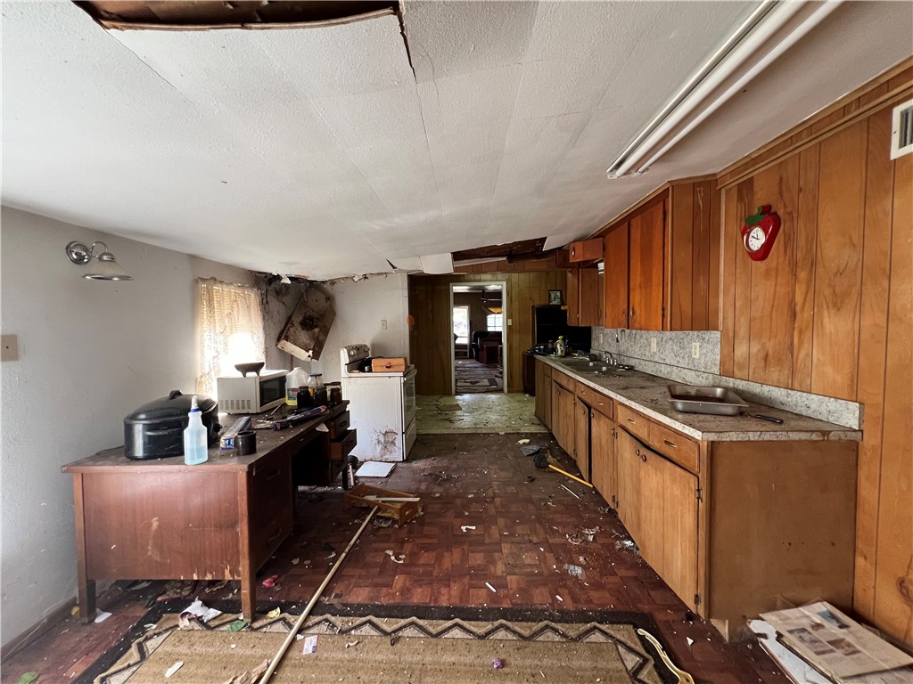 113 4th Street Mathis, TX 78368 - Photo 13 of 26 a kitchen with sink stove and refrigerator