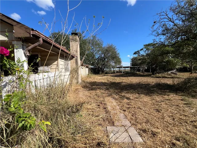 a view of a chairs and table in patio with wooden fence
