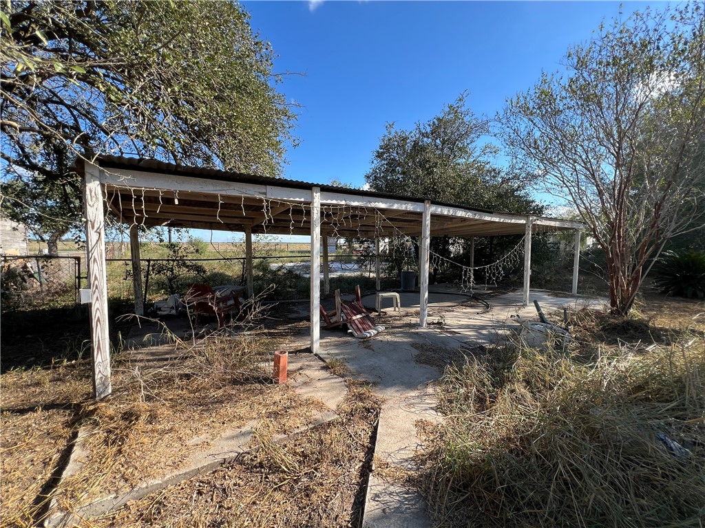 113 4th Street Mathis, TX 78368 - Photo 21 of 26 a view of backyard with green space and porch