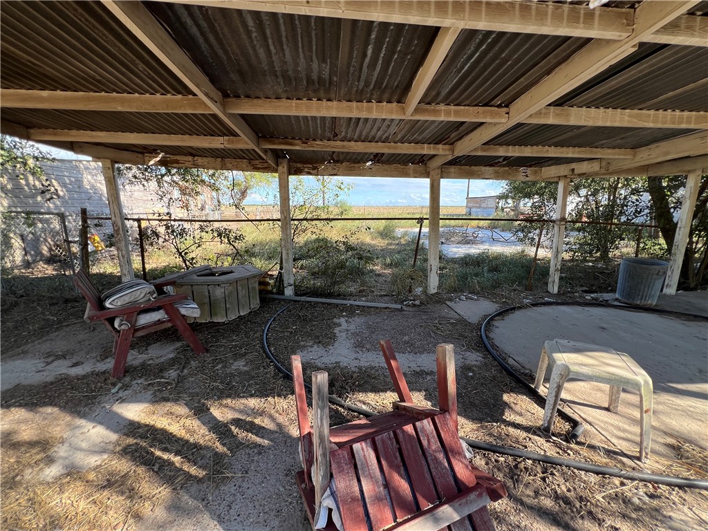 113 4th Street Mathis, TX 78368 - Photo 22 of 26 a view of a chairs and table in patio with wooden fence