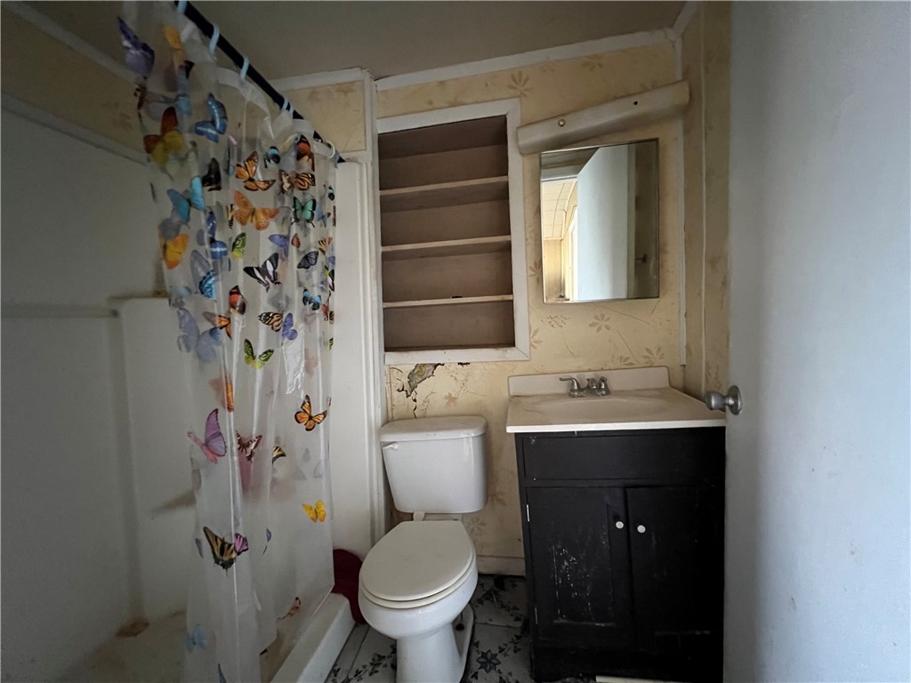 113 4th Street Mathis, TX 78368 - Photo 9 of 26 a bathroom with a sink toilet and shower