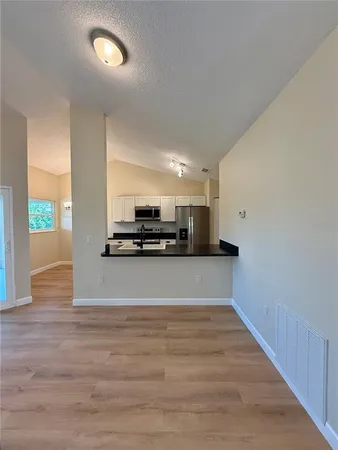 a view of kitchen with microwave and window