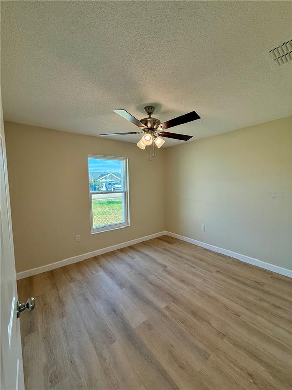 3541 65th Ave Circle East Sarasota, FL 34243 - Photo 10 of 17 wooden floor in an empty room