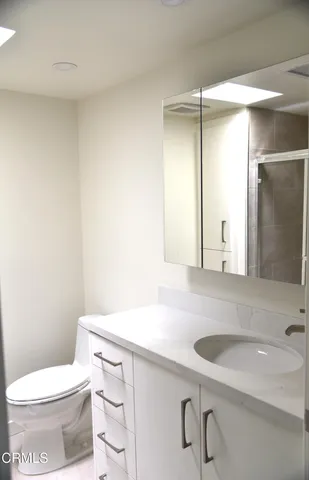 a bathroom with a sink a toilet and mirror