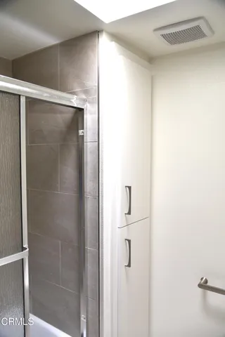 a bathroom with a glass shower door