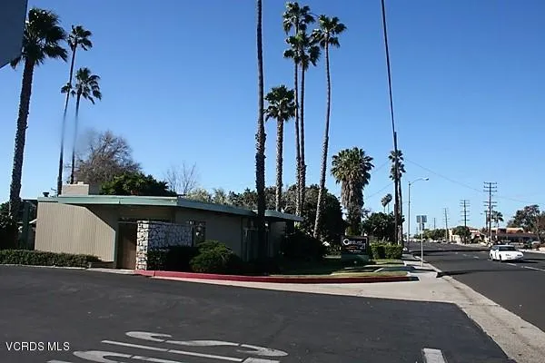 a view of a street with cars parked