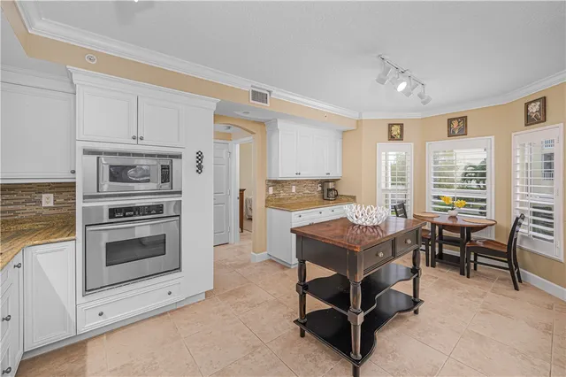 a kitchen with stainless steel appliances granite countertop a sink and cabinets