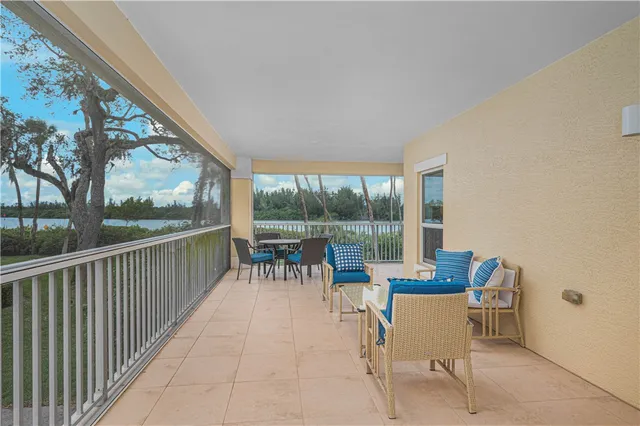 a view of a chairs and table in the balcony
