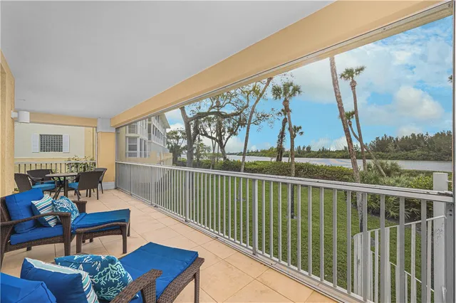 a living room with furniture rug and a table