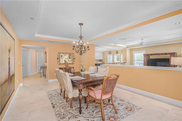 a view of a dining room with furniture wooden floor and chandelier