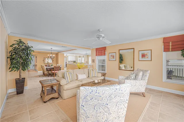 a living room with furniture and kitchen view