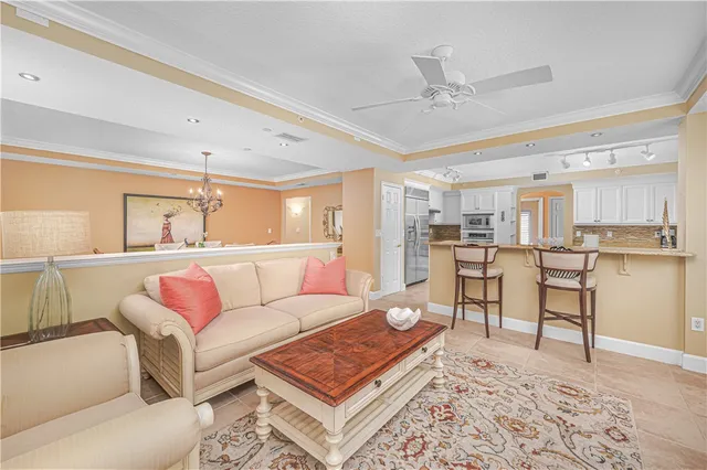 a living room with furniture a window and a flat screen tv