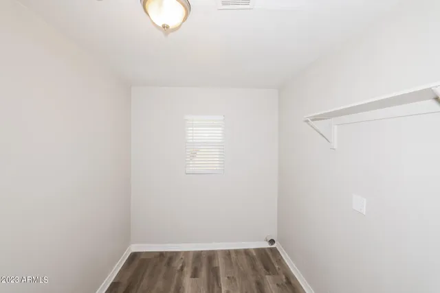 a white toilet sitting next to a bathroom sink and vanity
