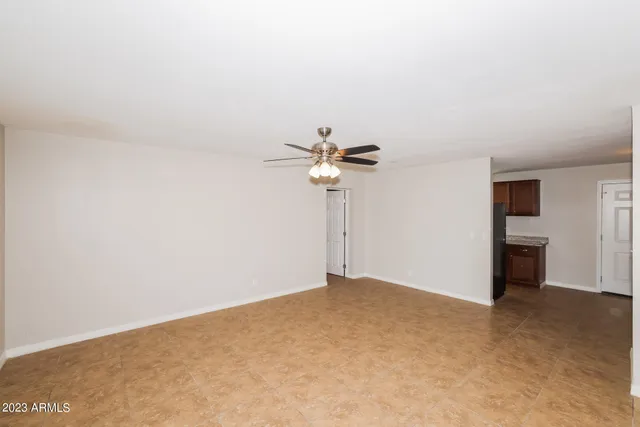 a view of empty room with ceiling fan