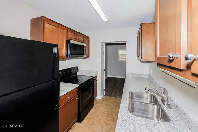 a view of a room with a ceiling fan and a window