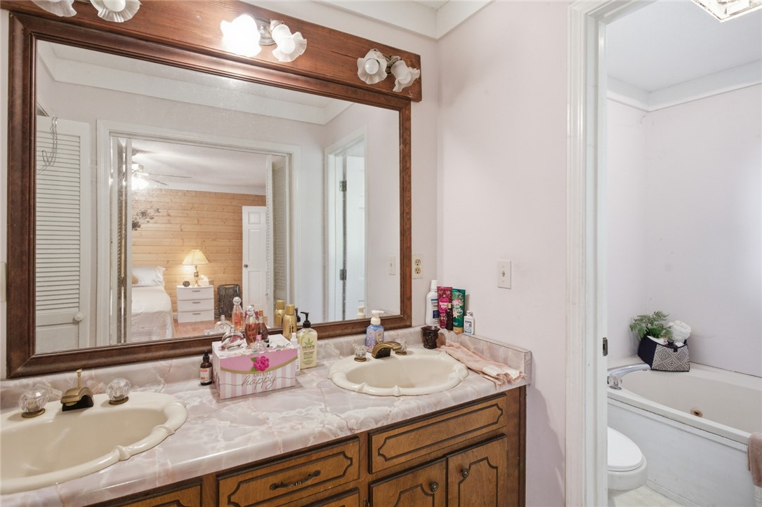 2001 Highway 59 Westminster, SC 29693 - Photo 17 of 38 This bathroom features a double vanity with ample counter space and a built-in tub for relaxation.