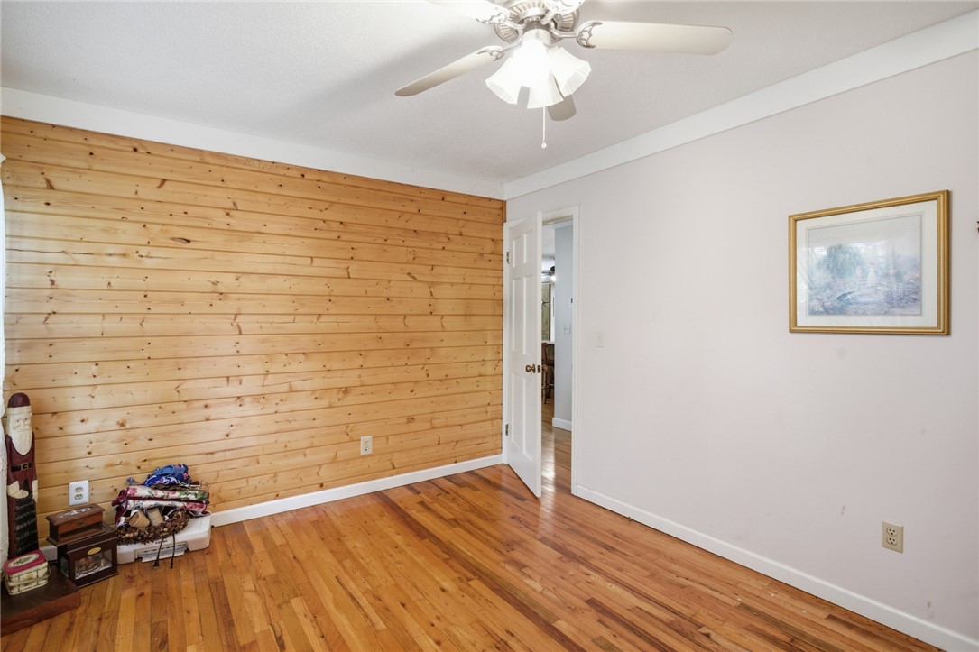 2001 Highway 59 Westminster, SC 29693 - Photo 23 of 38 This inviting bedroom features rich hardwood flooring and a distinctive wood-paneled accent wall.