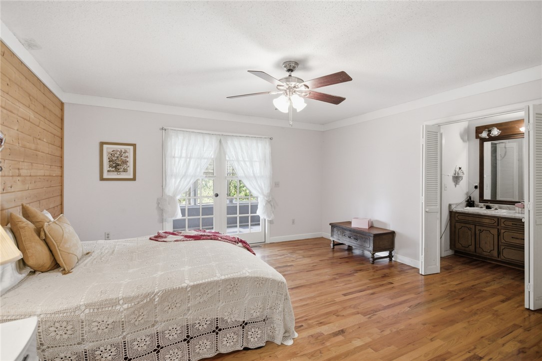 2001 Highway 59 Westminster, SC 29693 - Photo 24 of 38 This spacious bedroom offers hardwood flooring, a ceiling fan, and access to a private balcony.