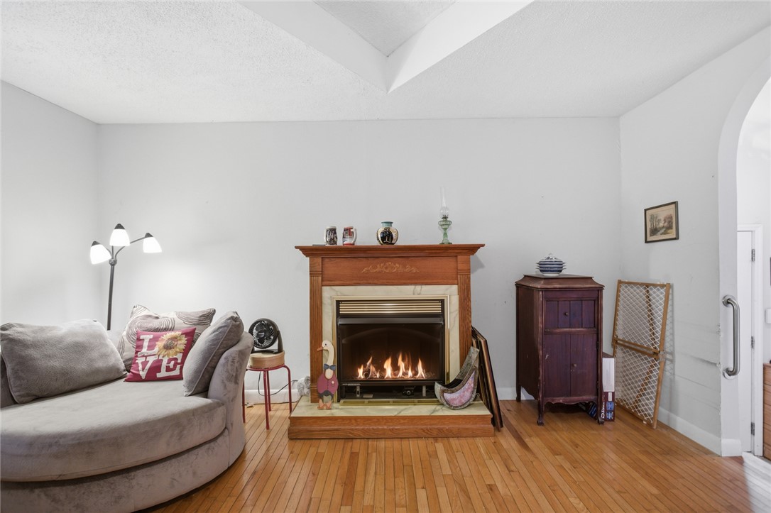 2001 Highway 59 Westminster, SC 29693 - Photo 29 of 38 This inviting living space features a cozy fireplace and warm hardwood flooring, ideal for comfortable gatherings.