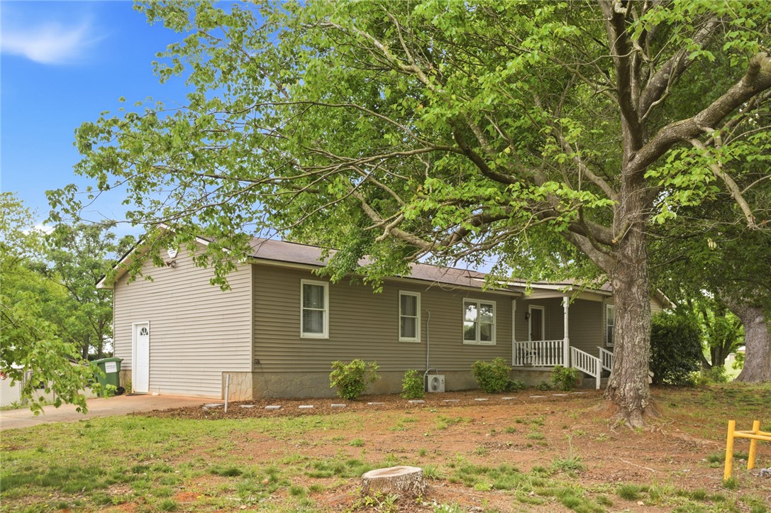 2001 Highway 59 Westminster, SC 29693 - Photo 3 of 38 This charming home offers a tranquil setting with mature trees and a welcoming front porch.