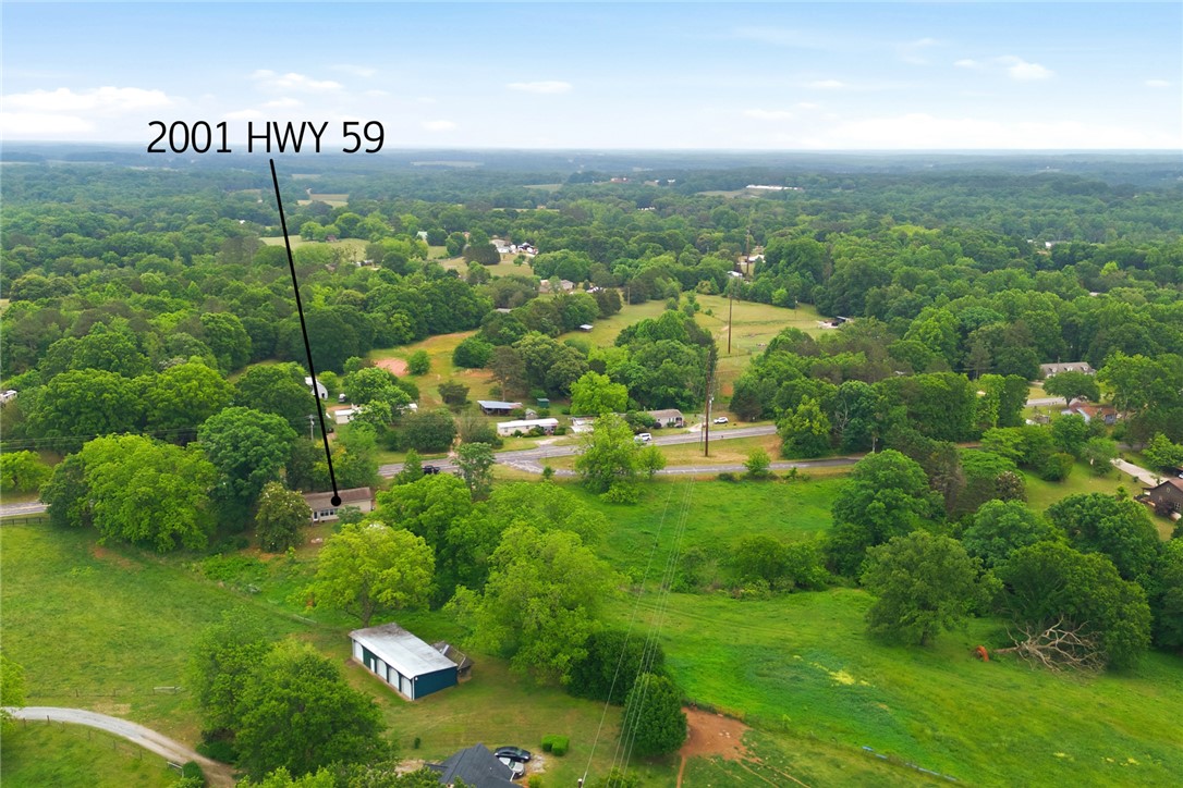 2001 Highway 59 Westminster, SC 29693 - Photo 34 of 38 Expansive green acreage with a rural backdrop provides a serene setting for a peaceful homestead.