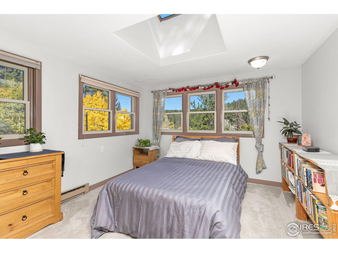 3072 Highway 72 Black Hawk, CO 80422 - Photo 14 of 36 a bedroom with a bed and a dresser in it