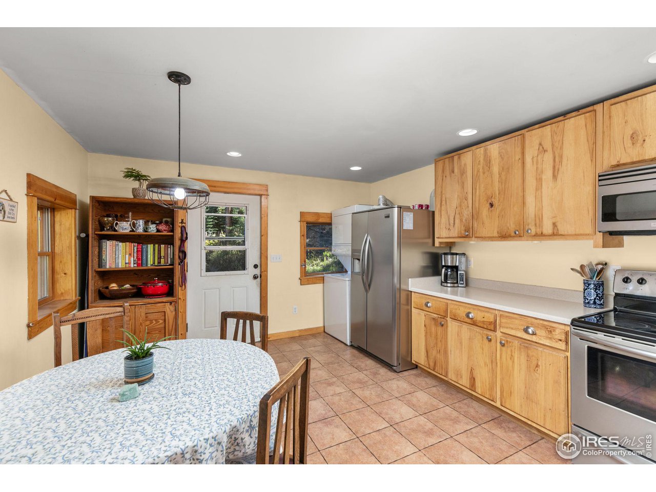 3072 Highway 72 Black Hawk, CO 80422 - Photo 6 of 36 a kitchen with stainless steel appliances kitchen island granite countertop a refrigerator a stove top oven a sink dishwasher and white cabinets with wooden floor