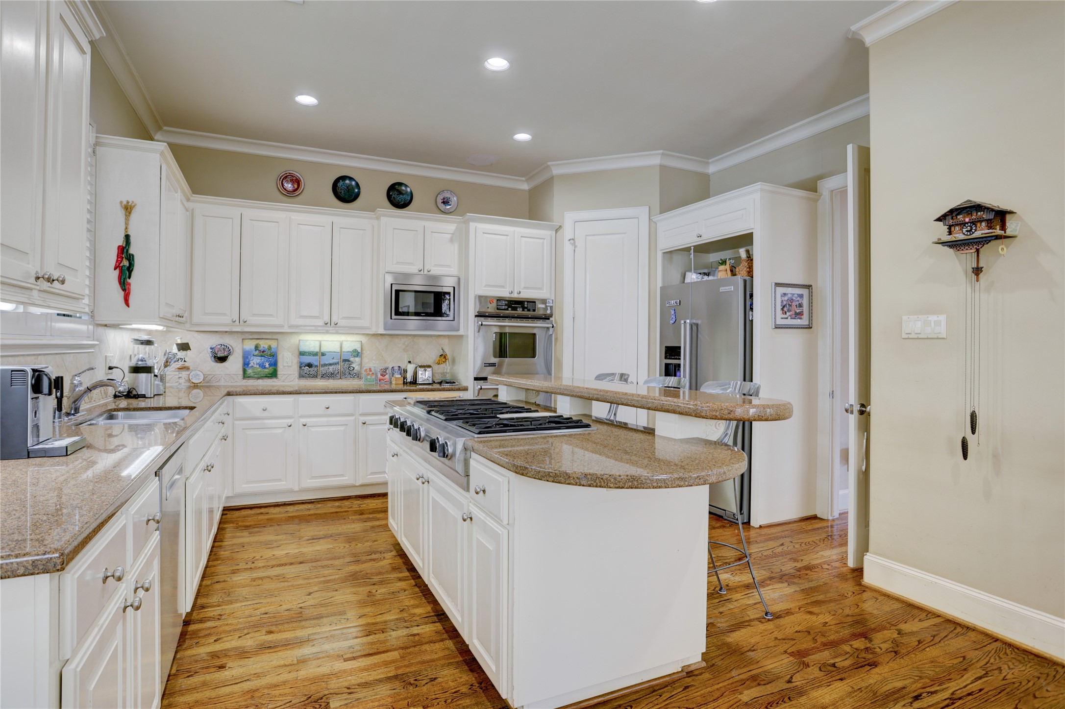 1008 Potomac Drive Houston, TX 77057 - Photo 20 of 34 a kitchen with kitchen island granite countertop a sink stove and refrigerator