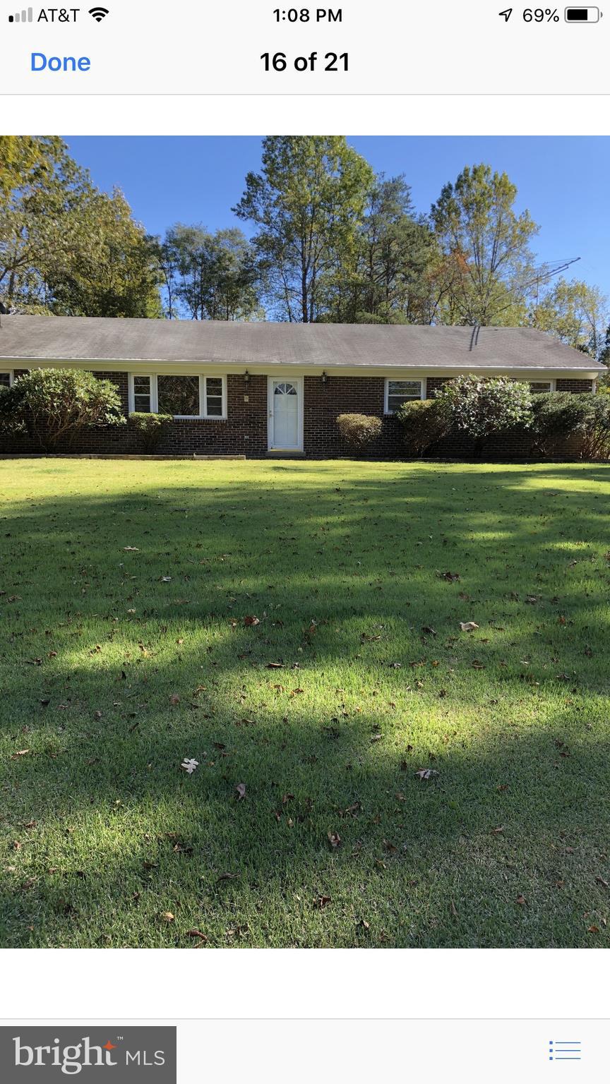 Sturdy brick rambler sits atop nice lot
