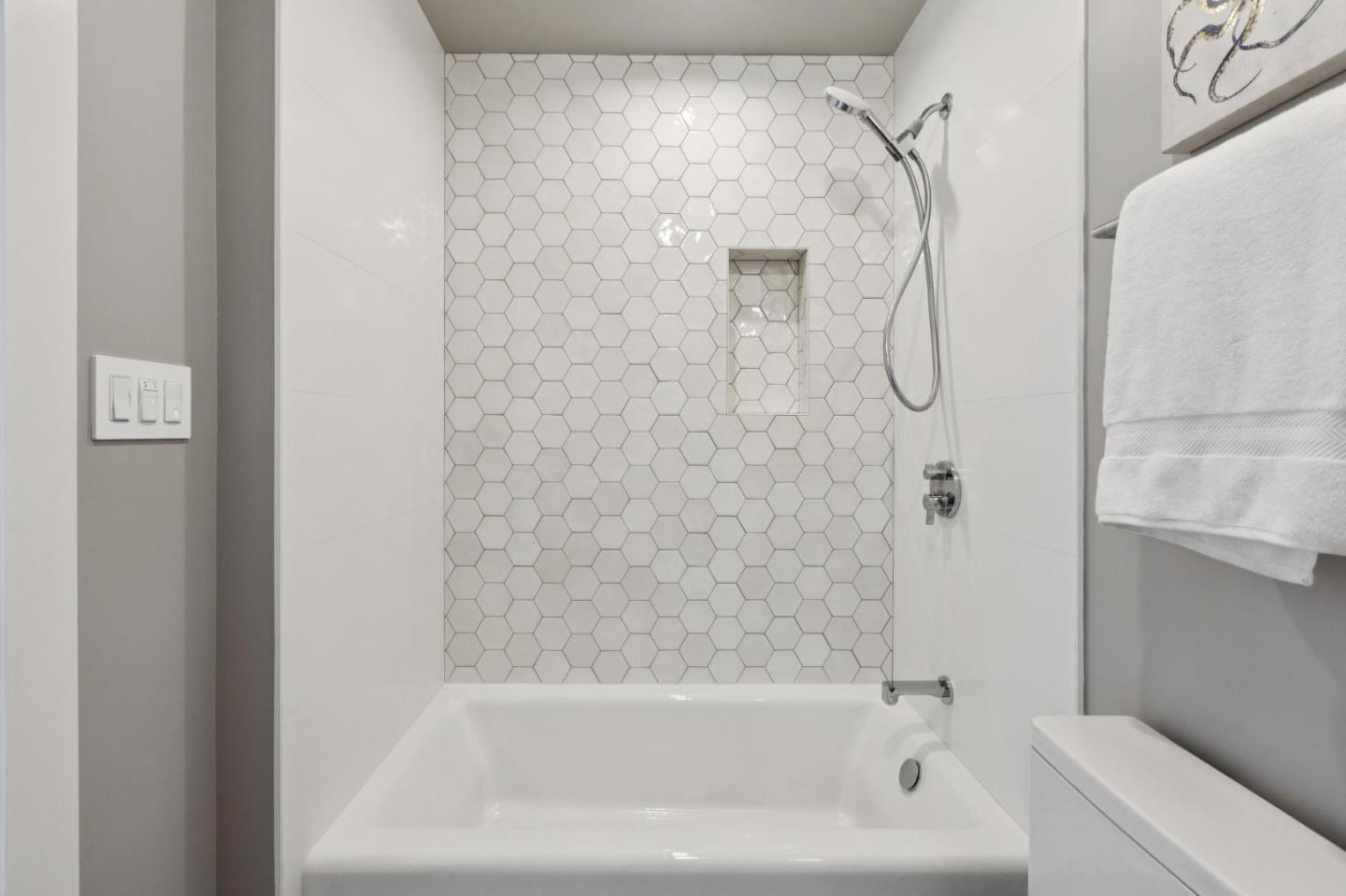 1433 Floribunda Avenue, Unit 5 Burlingame, CA 94010 - Photo 11 of 58 a close up of a bathtub curtain