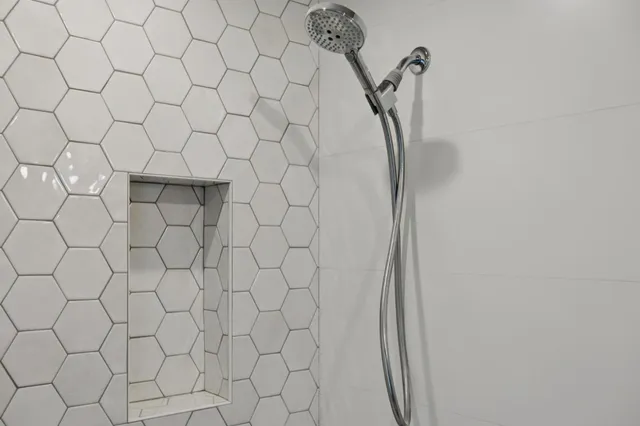 a view of a hallway with wooden floor and a living room