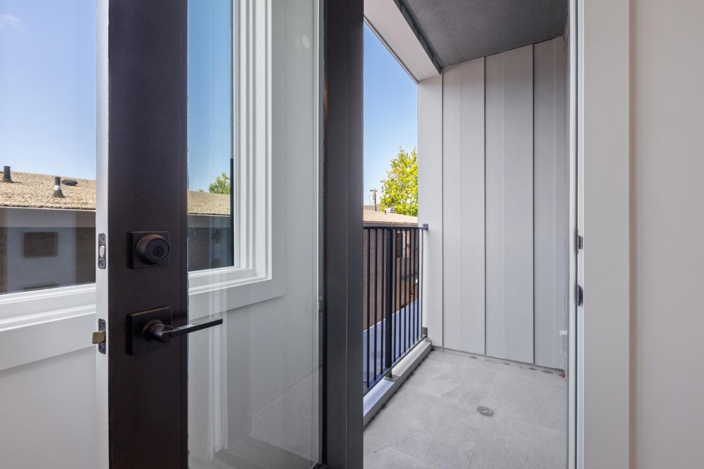 1433 Floribunda Avenue, Unit 5 Burlingame, CA 94010 - Photo 14 of 58 a view of a hallway with wooden floor and a living room