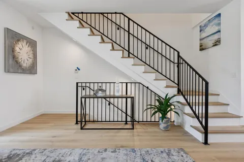a kitchen with appliances a sink and cabinets