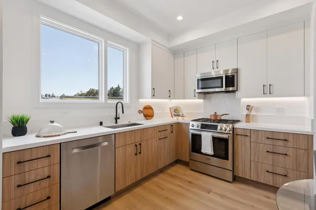 a stove top oven sitting inside of a kitchen