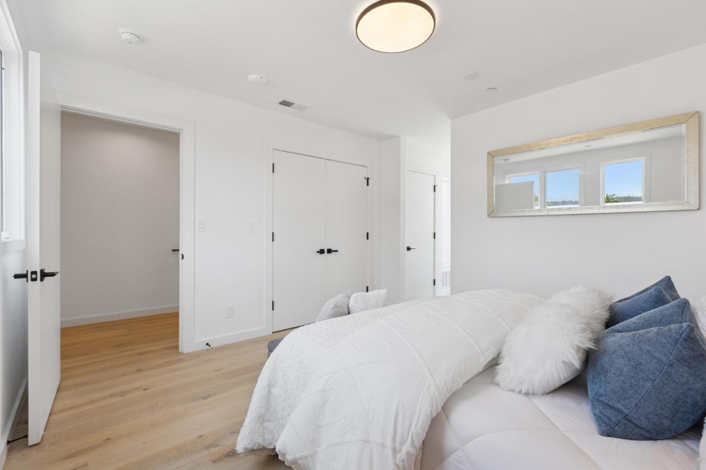 1433 Floribunda Avenue, Unit 5 Burlingame, CA 94010 - Photo 34 of 58 a spacious bedroom with a bed and a painting on the wall