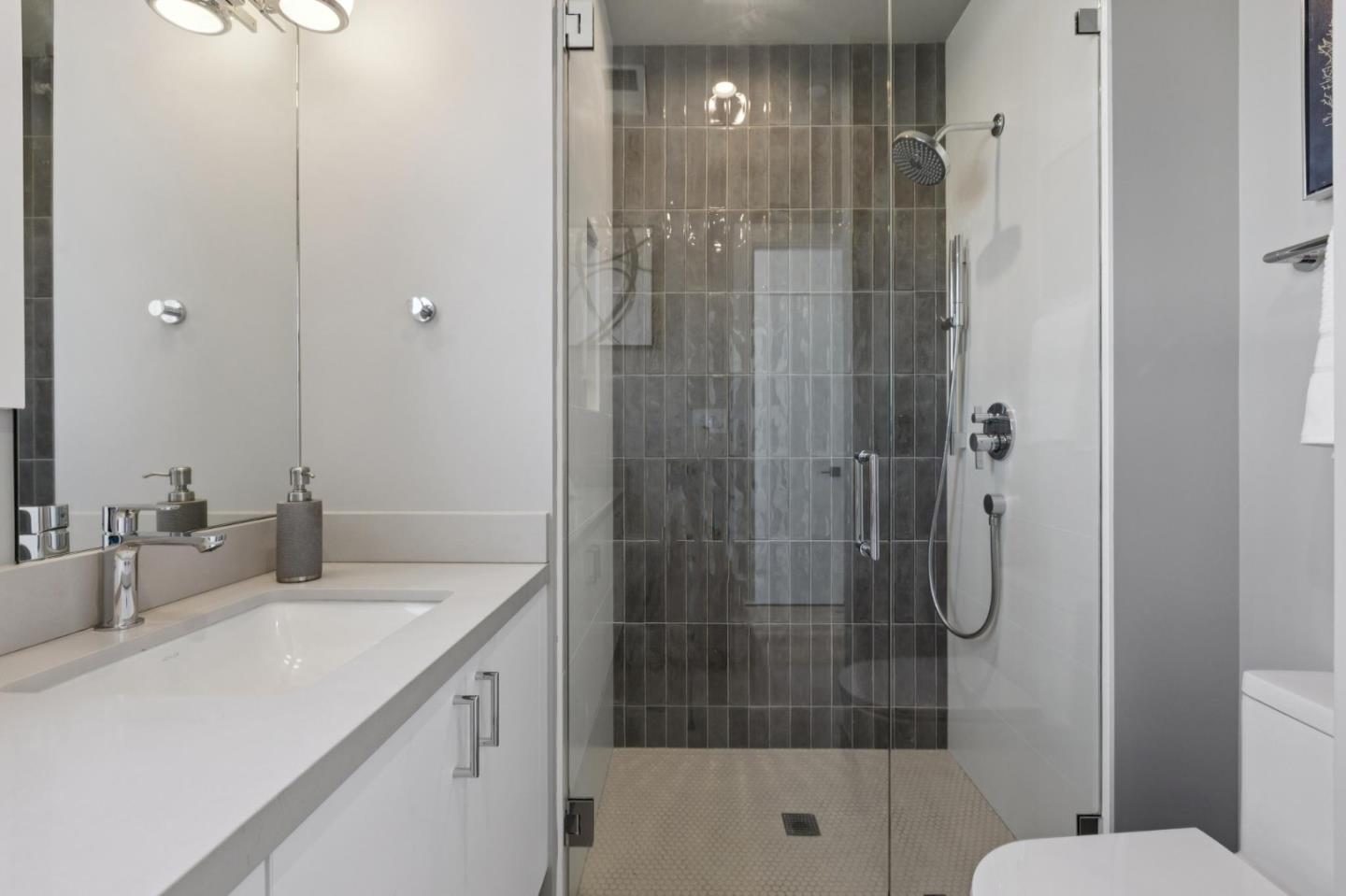 1433 Floribunda Avenue, Unit 5 Burlingame, CA 94010 - Photo 38 of 58 a bathroom with a shower sink and mirror