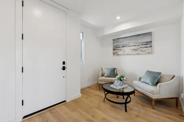 a living room with furniture and a potted plant