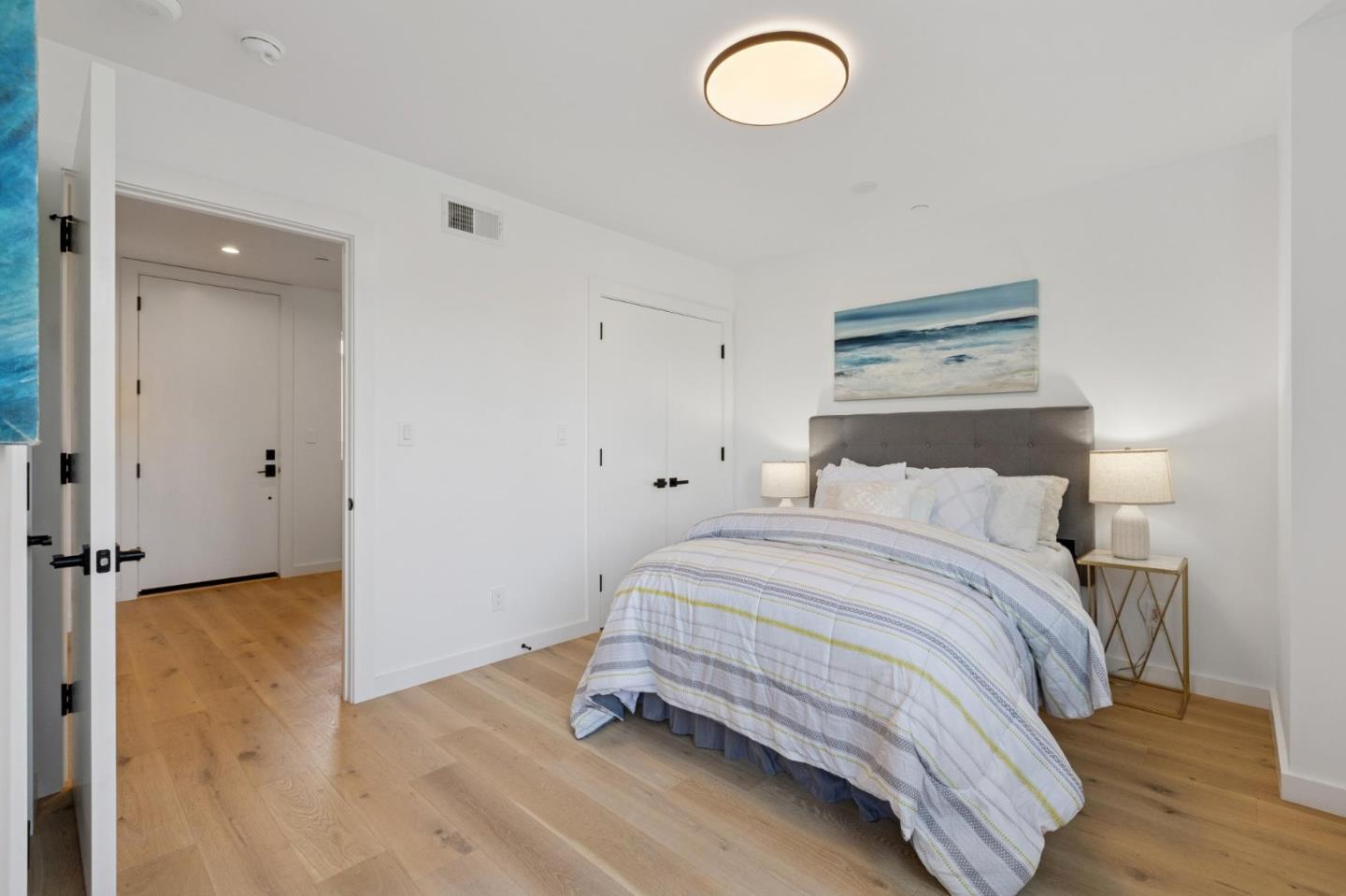1433 Floribunda Avenue, Unit 5 Burlingame, CA 94010 - Photo 8 of 58 a bedroom with a bed and wooden floor