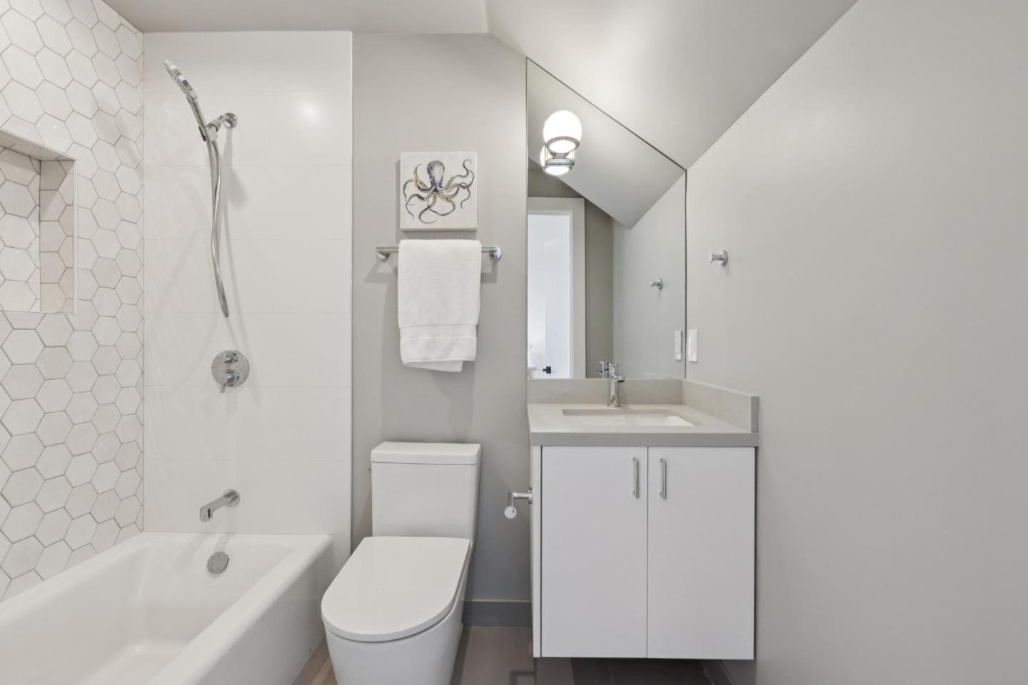 1433 Floribunda Avenue, Unit 5 Burlingame, CA 94010 - Photo 10 of 58 a bathroom with a toilet a sink and mirror