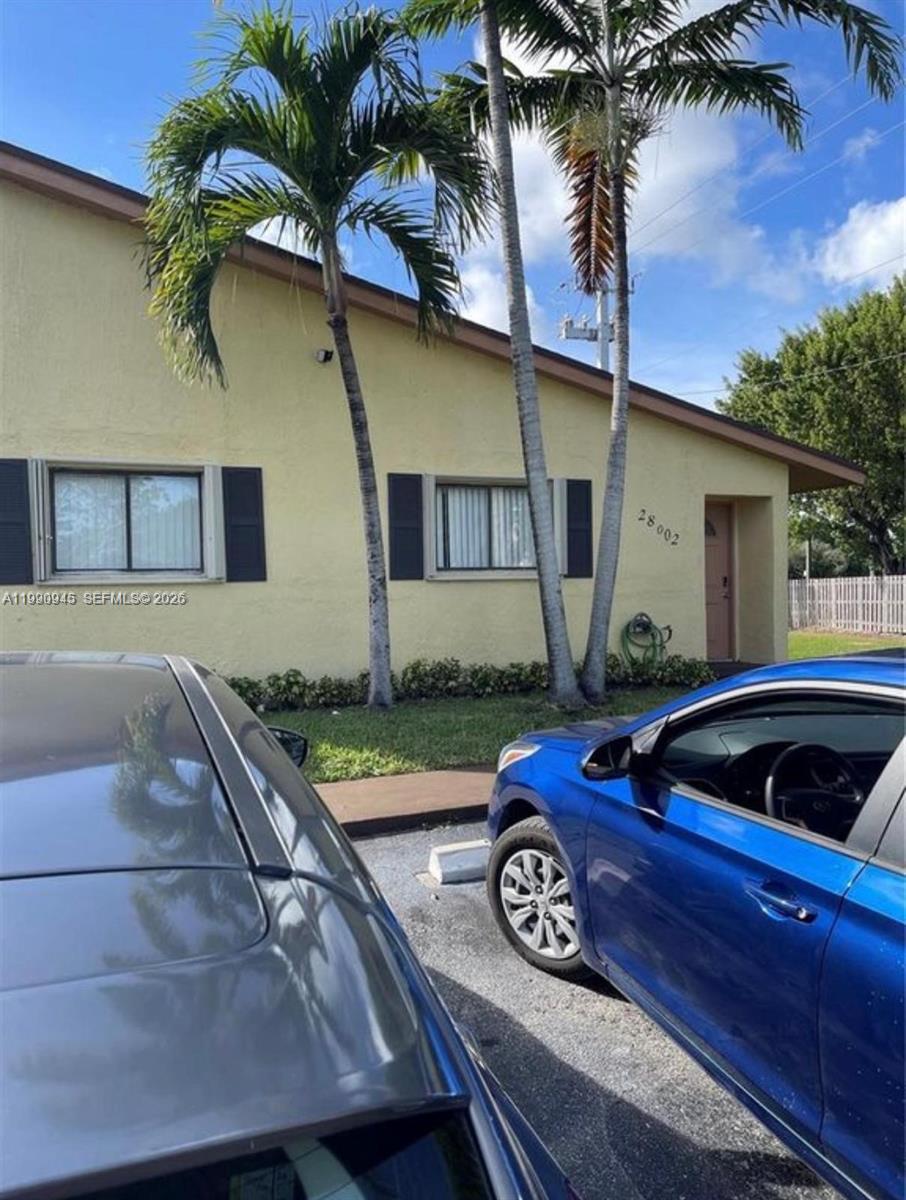 28002 Southwest 140th Court Homestead, FL 33033 - Photo 1 of 12 a front view of a house with garden