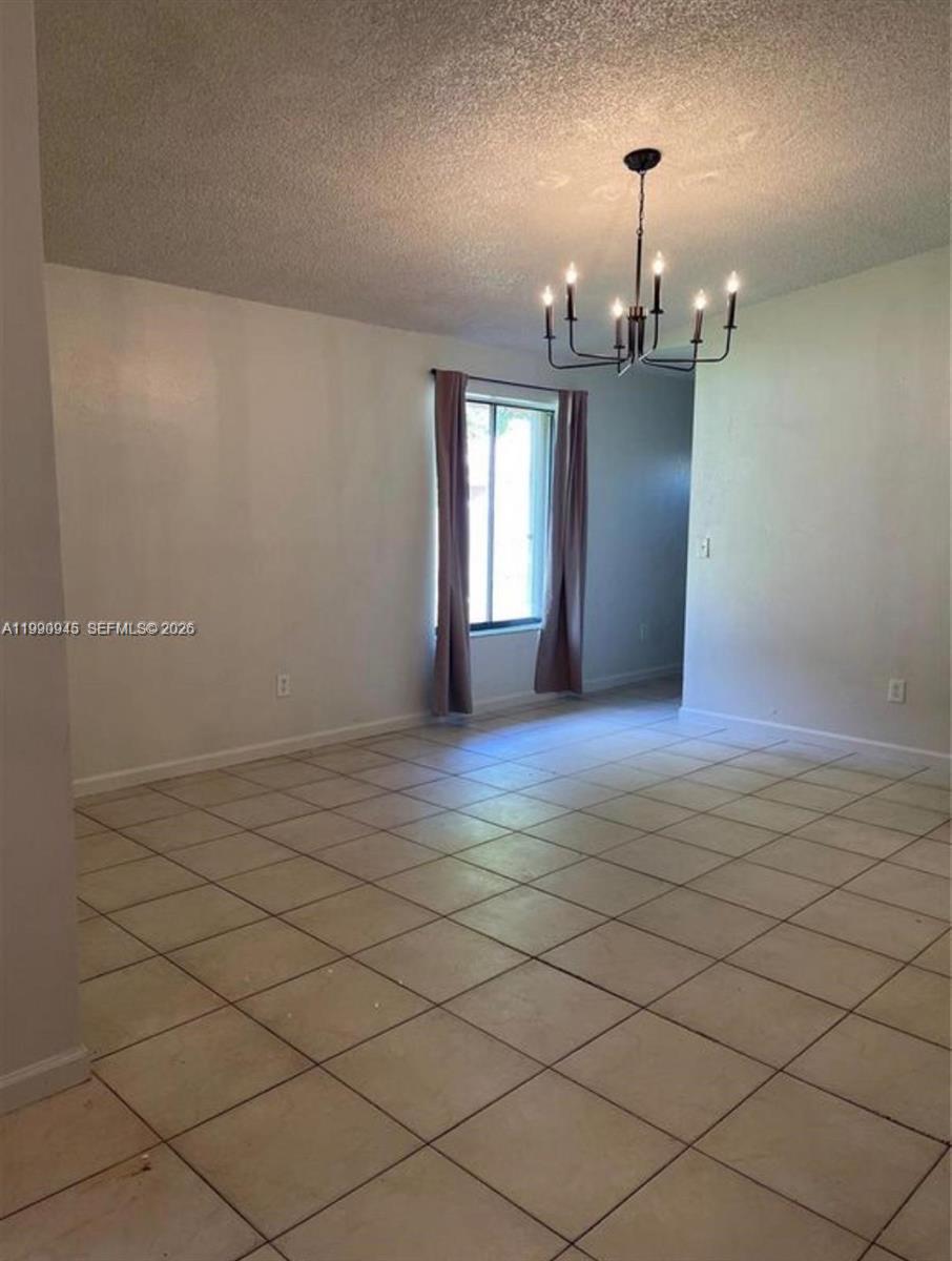28002 Southwest 140th Court Homestead, FL 33033 - Photo 3 of 12 an empty room with a empty space and window
